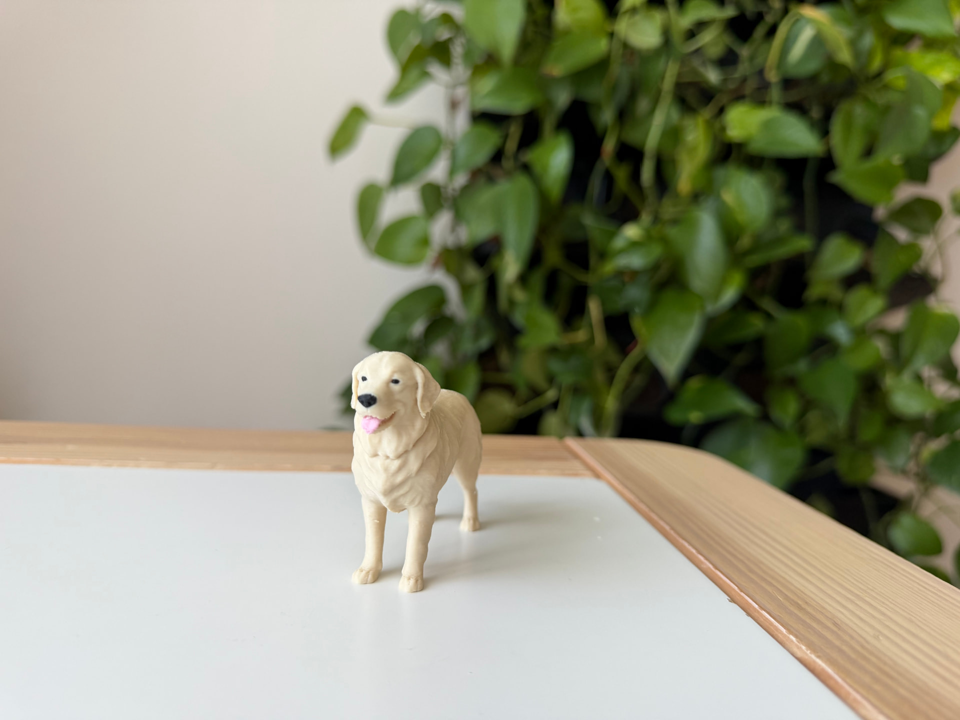 3D printed cream Golden Retriever figurine on a white table
